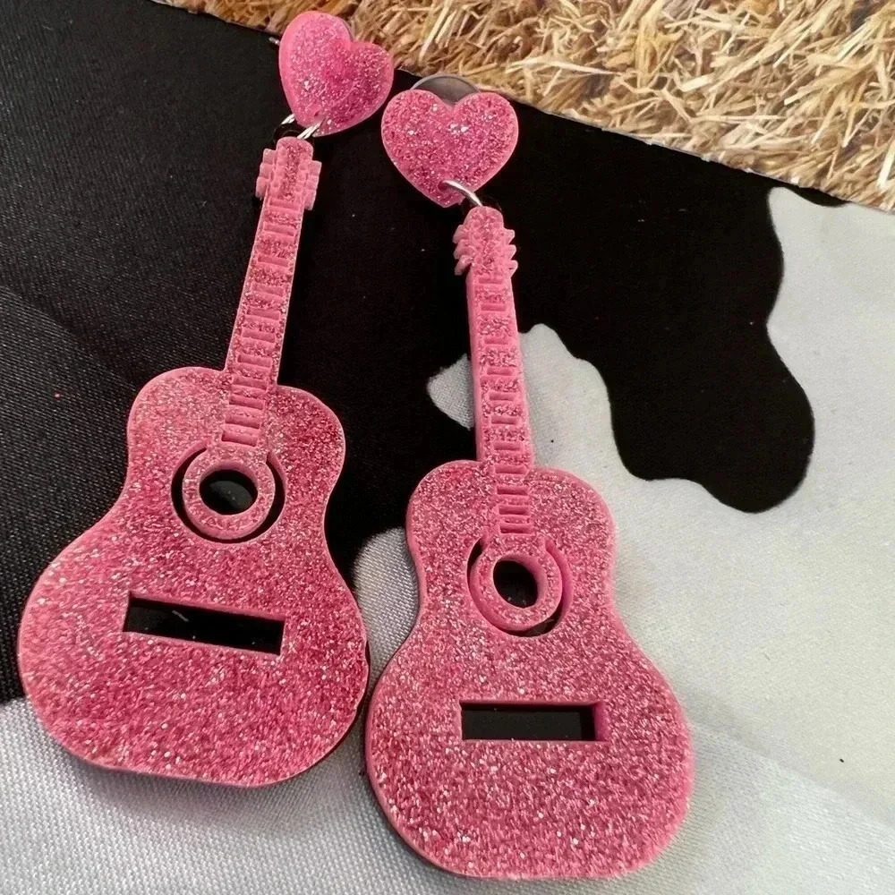 Earrings: pink plastic dangle guitar earrings